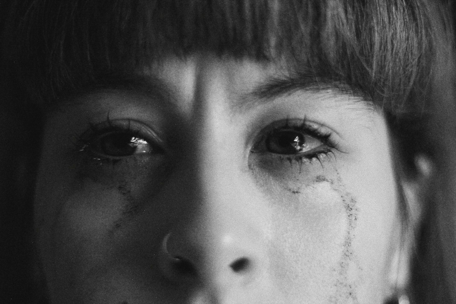 Crop crying woman with smearing makeup