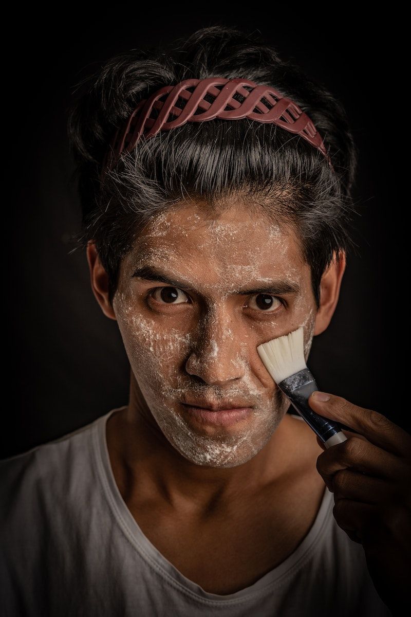 Man in White Crew Neck Shirt With White Powder on his Face