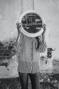 person holding mirror
